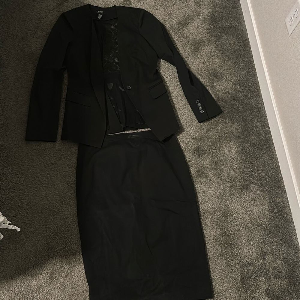 It’s a blazer and skirt set with lace in the back